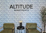Thumbnail 1 of 38 - Stylish lobby seating area with decorative wallpaper at Altitude Apartments, Moreno Valley, 92553