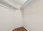 Thumbnail 24 of 26 - Oversized closet in Cielo apartment home with plank flooring, built in shelving and hanging racks