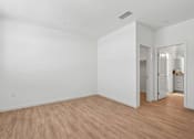 Thumbnail 29 of 38 - Empty bedroom with laminate flooring and walk-in closet at Altitude Apartments, California