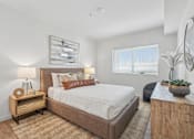 Thumbnail 19 of 38 - Bright bedroom with upholstered bed and modern furnishings at Altitude Apartments, Moreno Valley