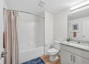 Thumbnail 23 of 38 - Contemporary bathroom with tub shower combo and vanity at Altitude Apartments, California, 92553
