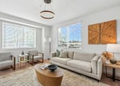 Thumbnail 17 of 38 - Contemporary living room with neutral furnishings and natural light at Altitude Apartments, Moreno Valley, CA 92553
