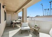 Thumbnail 24 of 38 - Covered patio with outdoor dining and lounge seating at Altitude Apartments, Moreno Valley, CA