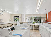 Thumbnail 12 of 26 - A white office with a clock on the wall.