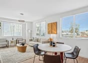Thumbnail 18 of 38 - Bright dining and living space with modern furniture at Altitude Apartments, Moreno Valley, California