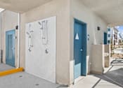 Thumbnail 10 of 38 - Outdoor shower facilities with restroom access doors at Altitude Apartments, California