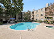 Thumbnail 11 of 37 - A swimming pool in a courtyard surrounded by buildings.