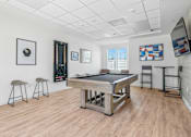 Thumbnail 6 of 38 - Game room with pool table and dart board at Altitude Apartments, Moreno Valley, 92553