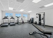 Thumbnail 12 of 38 - Fitness center with cardio and strength equipment at Altitude Apartments, Moreno Valley