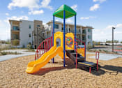 Thumbnail 36 of 38 - Colorful playground with slide and climbing structure at Altitude Apartments, Moreno Valley, CA 92553