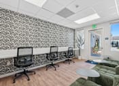 Thumbnail 3 of 38 - Coworking space with desk stations and lounge seating at Altitude Apartments, Moreno Valley, CA