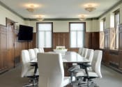 Thumbnail 1 of 12 - a conference room with a long table and white chairs