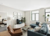 Thumbnail 12 of 12 - a living room with a couch chair and coffee table in front of a flat screen tv