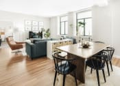 Thumbnail 10 of 12 - a view of a living room and dining room with a large wooden table and four black chairs