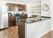 Thumbnail 9 of 12 - a kitchen with a large island and stainless steel appliances