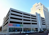 Thumbnail 5 of 12 - a parking garage with cars parked in front of it