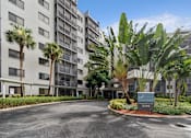 Thumbnail 7 of 37 - A building with a sign at Hampton Apartments, Clearwater, Florida