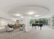 Thumbnail 20 of 37 - A room with a piano and chairs at Hampton Apartments, Clearwater, Florida