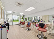 Thumbnail 15 of 37 - A hair salon with chairs and hairdressing stations at Hampton Apartments, Clearwater