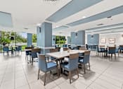 Thumbnail 30 of 37 - A large dining room with tables and chairs at Hampton Apartments, Florida, 33759