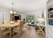 Thumbnail 6 of 37 - A well-lit, spacious dining room with a wooden table and chairs at Hampton Apartments, Clearwater 33759