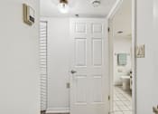 Thumbnail 37 of 37 - A white door is in a bathroom with a toilet and sink in the background at Hampton Apartments, Florida, 33759