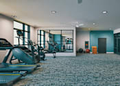 Thumbnail 21 of 28 - A gym with treadmills, weights, and exercise equipment.