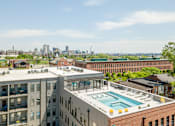Thumbnail 44 of 46 - the pool on the roof of a building with a city in the background at 1400 Russell Apartments, Saint Louis, Missouri