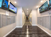Thumbnail 42 of 46 - a hallway with mailboxes and televisions in a building at 1400 Russell Apartments, Saint Louis, MO