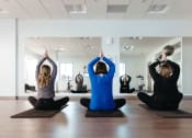 Thumbnail 12 of 33 - a group of people doing yoga in a studio at The Residences at Tesson Ridge, Saint Louis, 63128