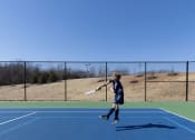 Thumbnail 8 of 33 - a young boy jumping in the air with a tennis racket at The Residences at Tesson Ridge, Saint Louis