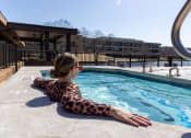 Thumbnail 6 of 33 - a woman relaxing in the pool at a hotel at The Residences at Tesson Ridge, Missouri, 63128