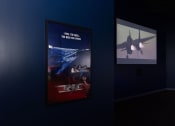 Thumbnail 30 of 33 - a poster and a television screen in a dark room at The Residences at Tesson Ridge, Saint Louis, 63128