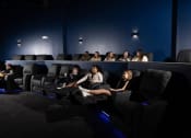 Thumbnail 32 of 33 - a crowd of people watching a movie in a darkened movie theater at The Residences at Tesson Ridge, Saint Louis, Missouri