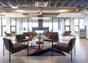 Thumbnail 2 of 33 - a large lobby with chairs and a table at The Residences at Tesson Ridge, Saint Louis, Missouri