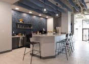 Thumbnail 4 of 33 - a kitchen with a counter and chairs in a lobby at The Residences at Tesson Ridge, Saint Louis, MO, 63128