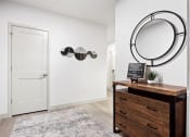 Thumbnail 24 of 33 - a hallway with a mirror and a dresser at The Residences at Tesson Ridge, Saint Louis