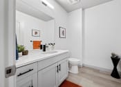 Thumbnail 29 of 33 - a bathroom with a sink and a toilet and a mirror at The Residences at Tesson Ridge, Saint Louis, 63128