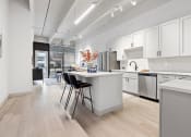 Thumbnail 27 of 33 - an open kitchen and dining area with a table and chairs at The Residences at Tesson Ridge, Missouri, 63128