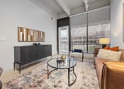 Thumbnail 15 of 33 - a living room with a couch and a table at The Residences at Tesson Ridge, Saint Louis, 63128