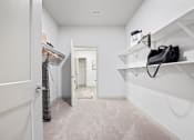 Thumbnail 25 of 33 - a closet in a bedroom with a door to a bathroom at The Residences at Tesson Ridge, Missouri