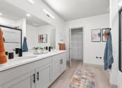 Thumbnail 20 of 33 - a bathroom with a sink and a shower and a mirror at The Residences at Tesson Ridge, Saint Louis, MO, 63128