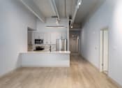 Thumbnail 55 of 112 - A spacious kitchen with a white countertop and wooden flooring. at The Residences at Tesson Ridge Apartments, Saint Louis