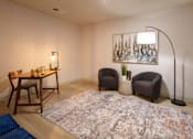 Thumbnail 46 of 112 - A room with a rug, a table with chairs, a floor lamp, and a painting on the wall. at The Residences at Tesson Ridge Apartments, Missouri, 63128