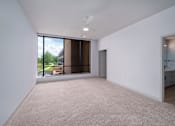 Thumbnail 38 of 112 - A large empty room with a window overlooking a building. at The Residences at Tesson Ridge Apartments, Saint Louis, MO