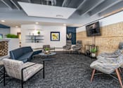 Thumbnail 52 of 112 - A modern living room with a grey carpet and a stone patterned chair. at The Residences at Tesson Ridge Apartments, Saint Louis, MO