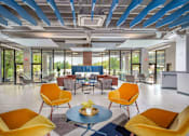 Thumbnail 45 of 112 - A modern room with yellow chairs and a blue table. at The Residences at Tesson Ridge Apartments, Saint Louis, MO