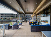 Thumbnail 44 of 112 - A patio area with blue couches and tables. at The Residences at Tesson Ridge Apartments, Saint Louis, MO, 63128