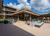 Thumbnail 94 of 112 - A large outdoor swimming pool area with a building in the background. at The Residences at Tesson Ridge Apartments, Missouri