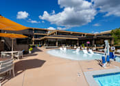 Thumbnail 92 of 112 - A sunny day at the pool with chairs and umbrellas. at The Residences at Tesson Ridge Apartments, Saint Louis, Missouri